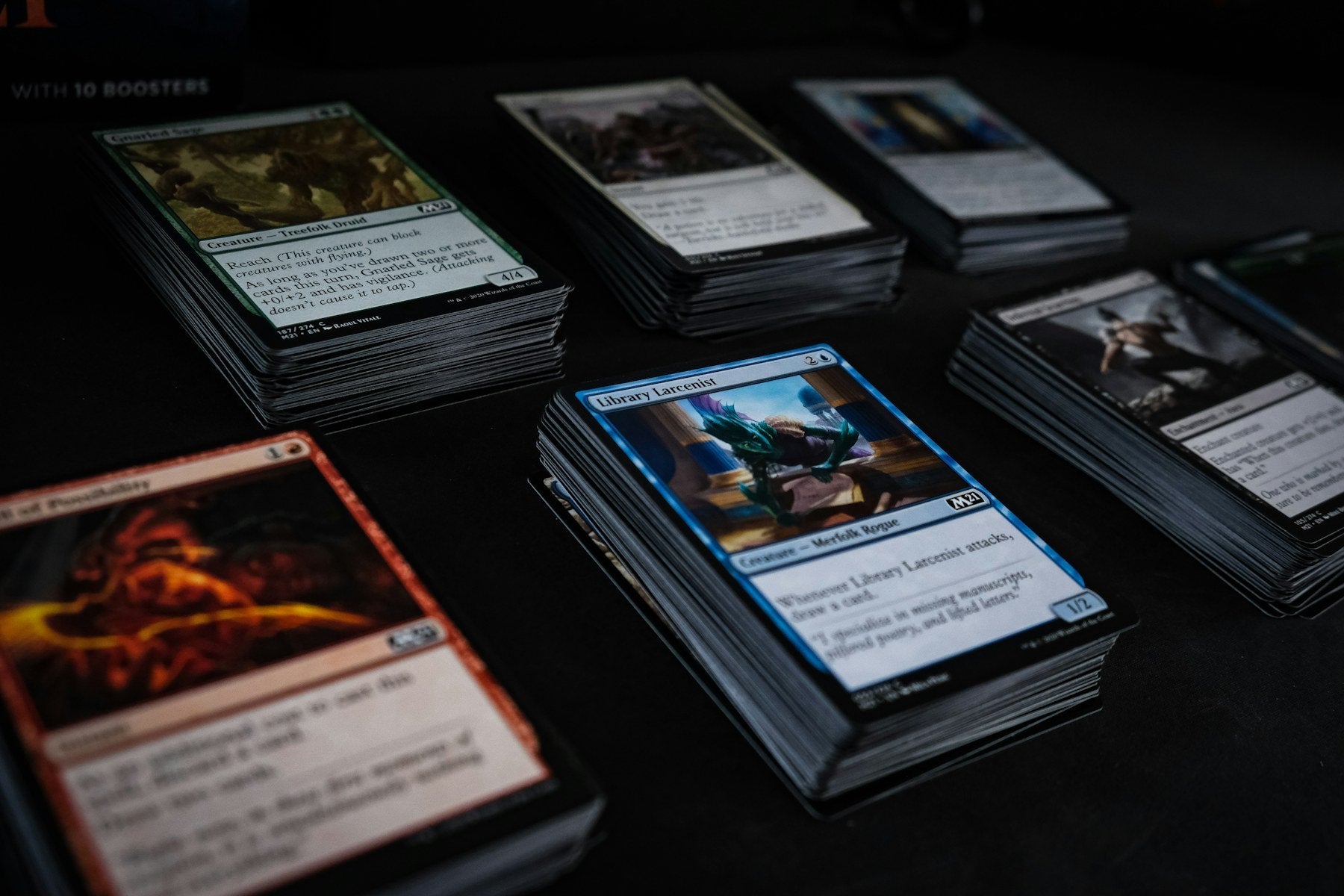 Stacks of collectible trading-card decks arranged on a collector table